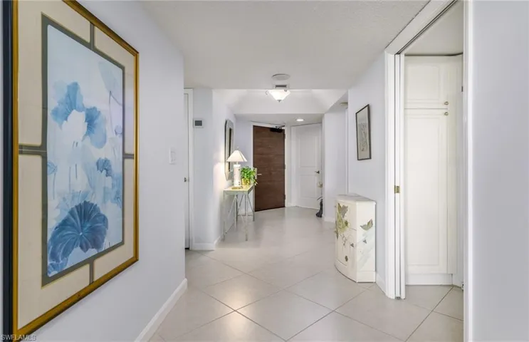 Hallway with light tile patterned floors