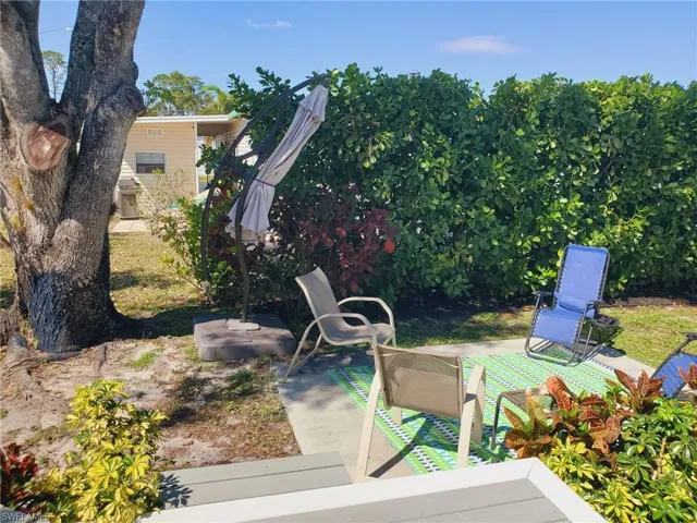 Step outside the Primary bedroom to the patio and tropical setting.