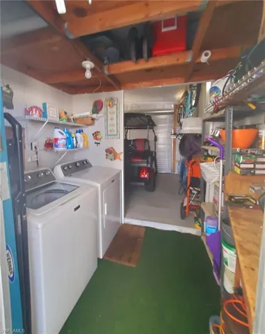 Spacious shed with washer & dryer. Overhead door in the back.