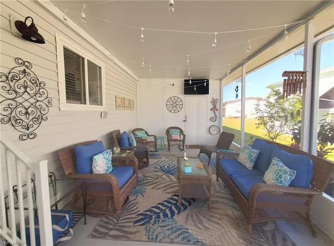 Screened breezeway leads to the shed and provides extra space for entertaining.