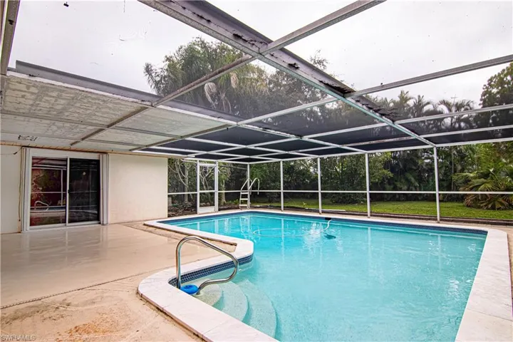 Swimming pool with a lanai, a patio area, and a sunroom