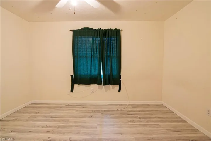 Spare room featuring wood finished floors and a ceiling fan