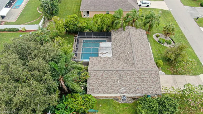 Aerial view of property and surrounding area with a pool