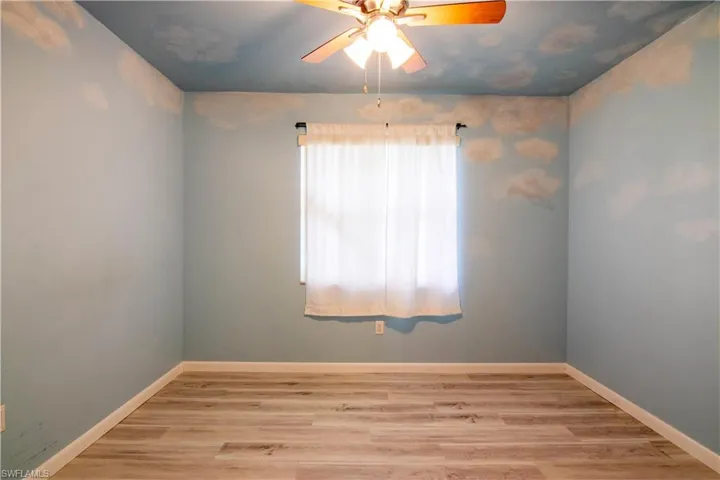 Unfurnished room with light wood-style floors and ceiling fan