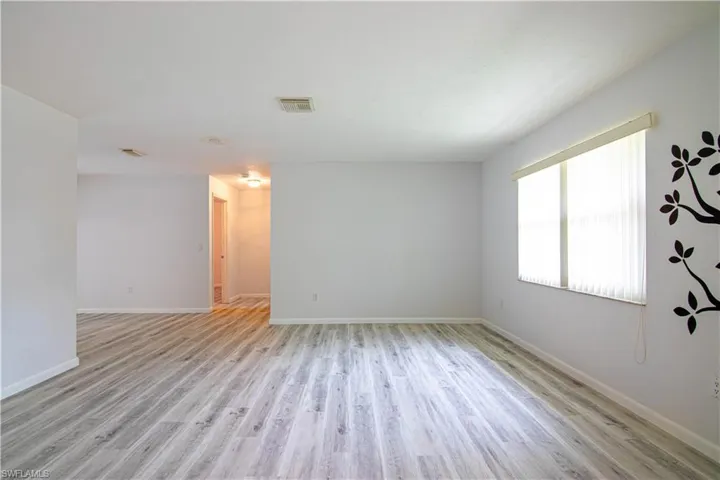 Unfurnished room featuring light wood-type flooring and baseboards