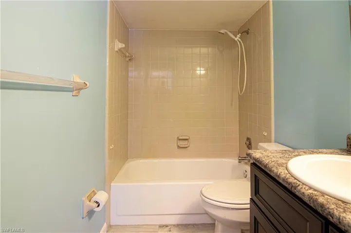 Bathroom featuring bathing tub / shower combination and vanity
