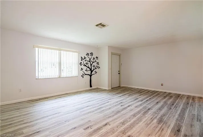 Unfurnished room featuring light wood-style flooring and baseboards