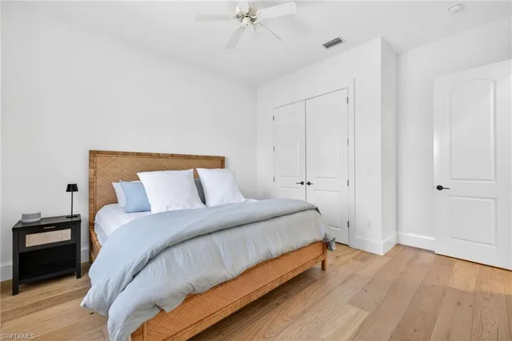 Bedroom featuring ceiling fan, a closet, and light wood finished floors