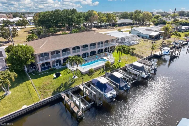 Waterfront property featuring multiple boat lifts and direct canal access