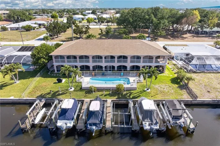 Waterfront property featuring multiple boat lifts and direct canal access