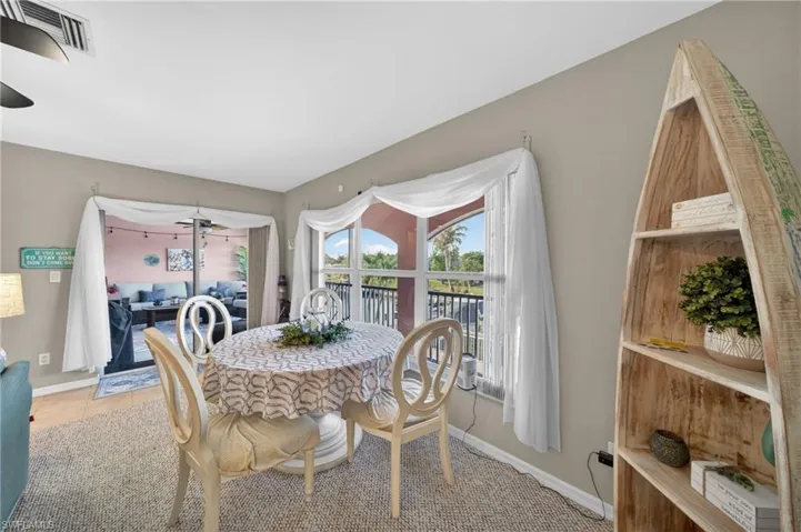 Dining area featuring a large window, sliding glass door, and neutral wall paint