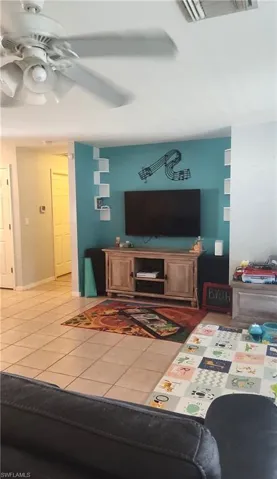 Spacious living room open to kitchen and sliders to lanai.