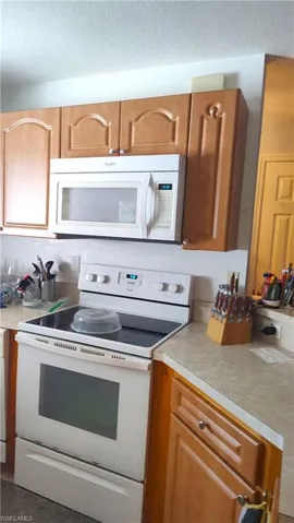 Kitchen opens to living and dining areas