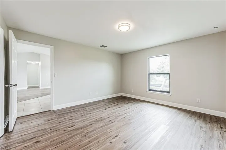 Empty room featuring wood-type flooring