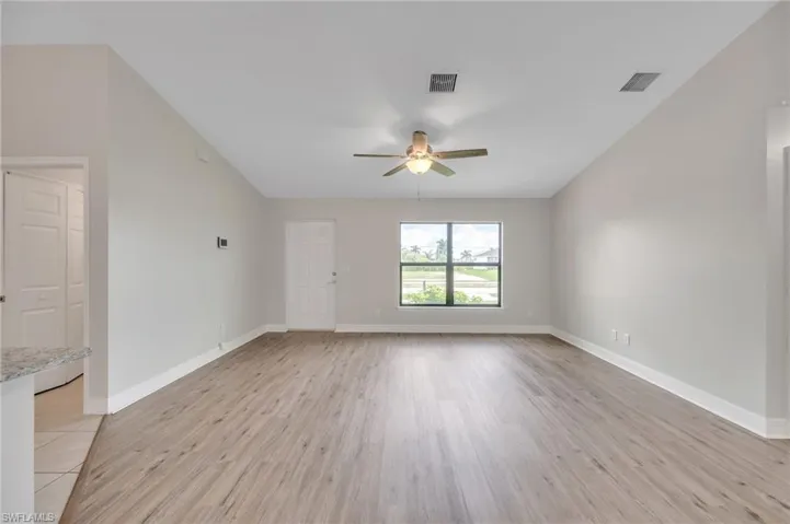 Empty room featuring light hardwood / wood-style flooring and ceiling fan