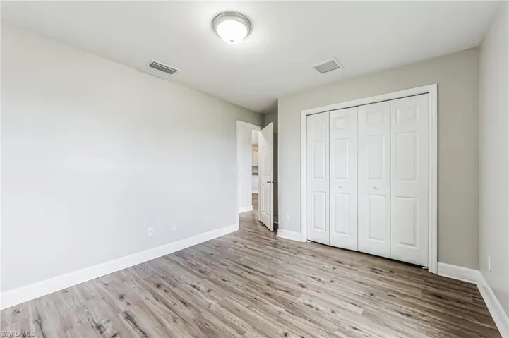 Unfurnished bedroom featuring light hardwood / wood-style flooring and a closet