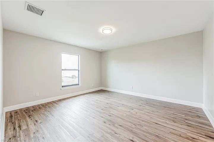 Empty room featuring light wood-type flooring