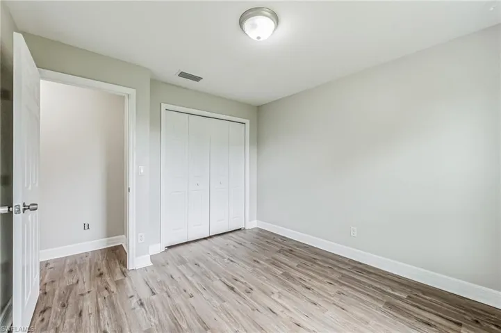 Unfurnished bedroom featuring light hardwood / wood-style flooring and a closet