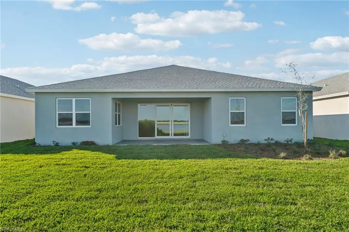 Rear view of house with a lawn