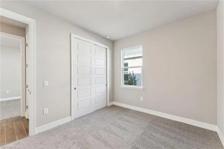 Unfurnished bedroom featuring a closet and carpet