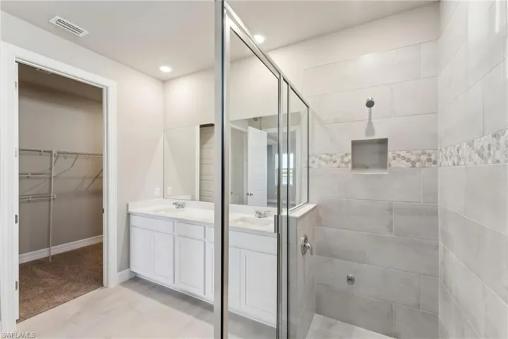 Bathroom with vanity and walk in shower