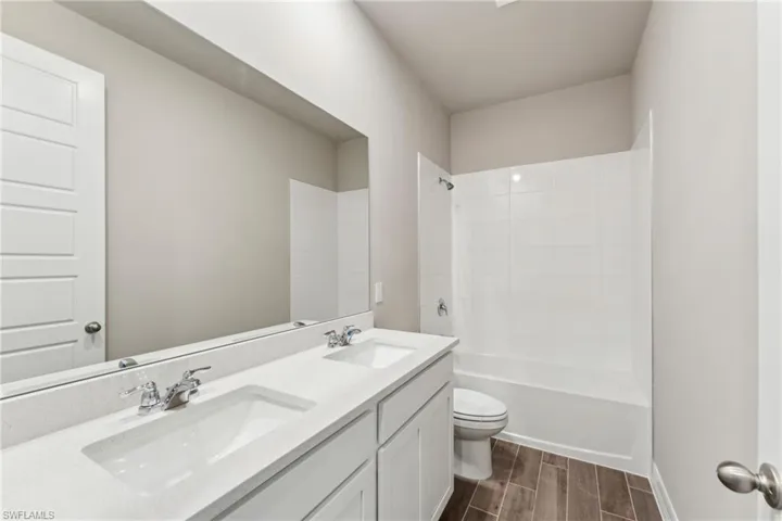 Full bathroom featuring vanity, shower / bathing tub combination, and toilet
