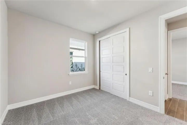 Unfurnished bedroom with carpet and a closet