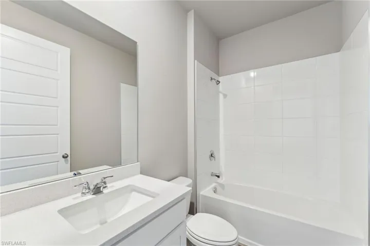 Full bathroom with toilet, vanity, and bathtub / shower combination