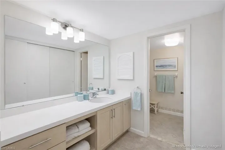 AI renovated/virtually staged. Full bath featuring vanity and baseboards