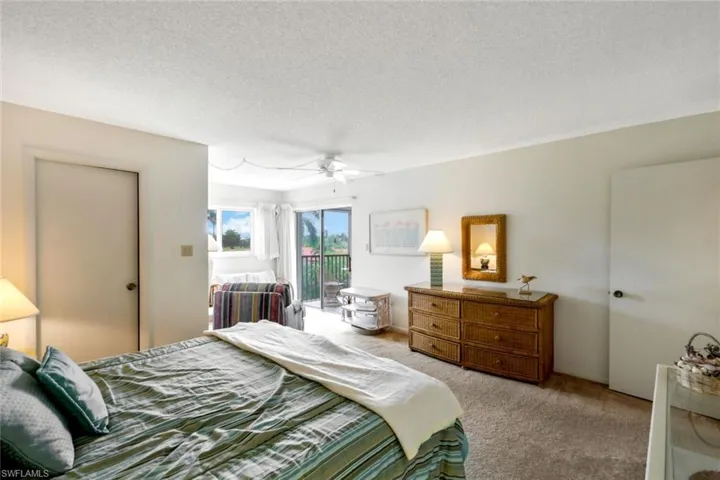 Primary bedroom with sliding glass door access to the lanai.