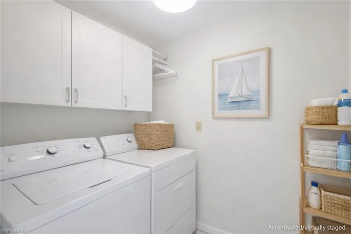 AI renovated/virtually staged. Laundry area with washing machine and dryer and cabinet space