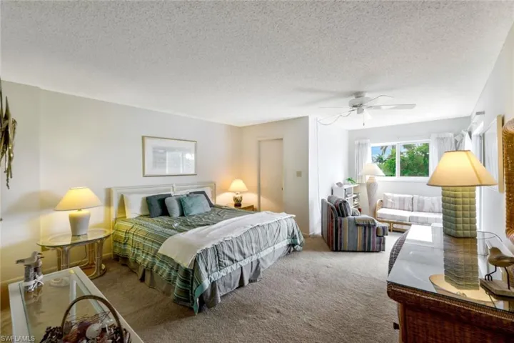 Primary bedroom with sliding glass door access to the lanai (to the right).