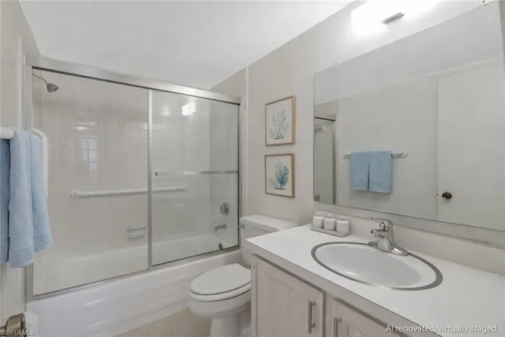 AI renovated/virtually staged. Full bathroom with enclosed tub / shower combo and vanity