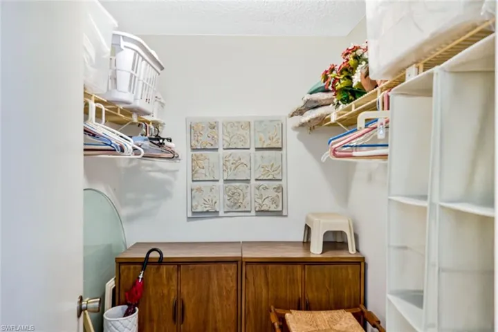 Primary bedroom walk in closet.