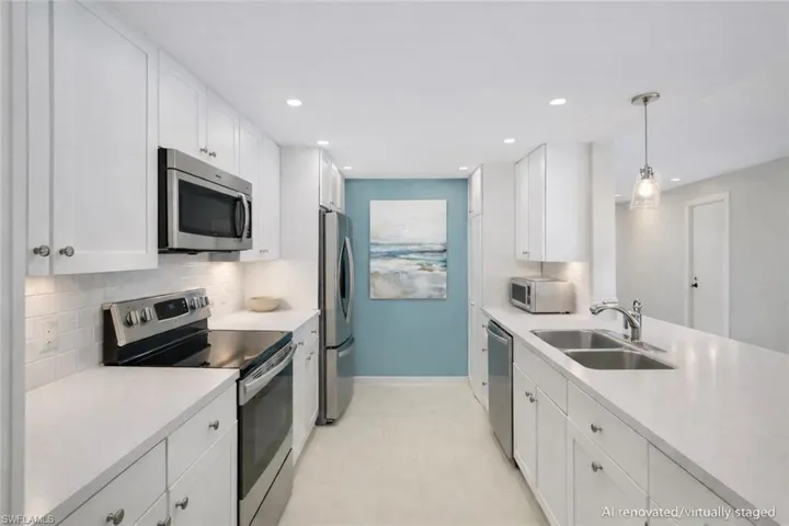 AI renovated/virtually staged. Kitchen featuring stainless steel appliances, white cabinets, hanging light fixtures, and light countertops