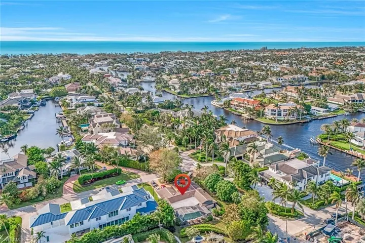 Aerial view of the corner property showing proximity to beach and canals. Deeded Boat dock is included in price.
