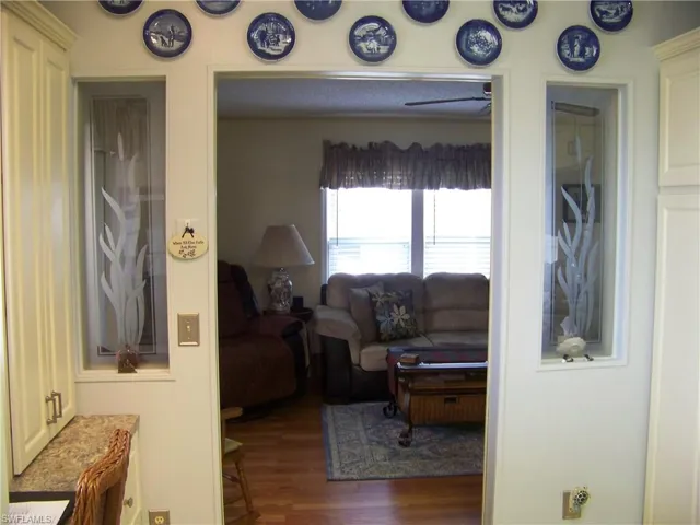 two deco glass windows on either side of kitchen entry.