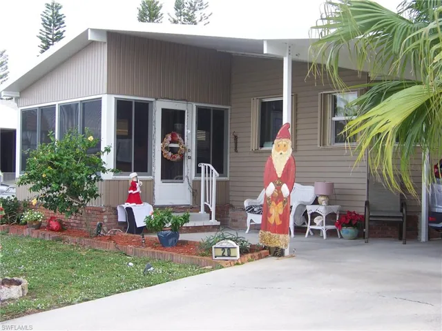 Exterior shot, nice siding and large carport to right side.