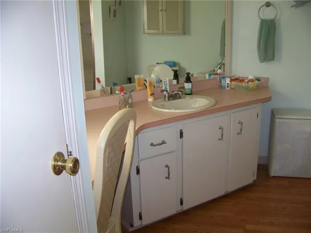 Master bath with vanity/make-up area with chair.