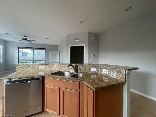patterned flooring, sink, stainless steel dishwasher, and ceiling fan