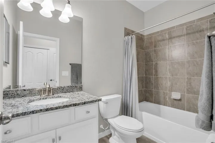 Bathroom with shower / tub combo and vanity