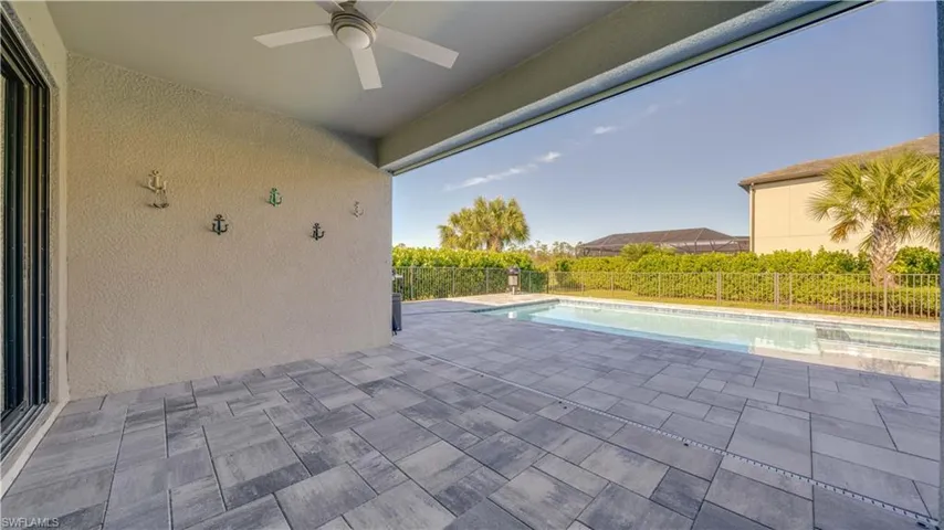 View of pool featuring a patio, a fenced backyard, and a ceiling fan