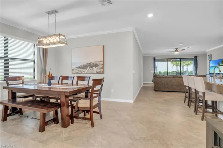 Dining room featuring crown molding, a ceiling fan, and recessed lighting