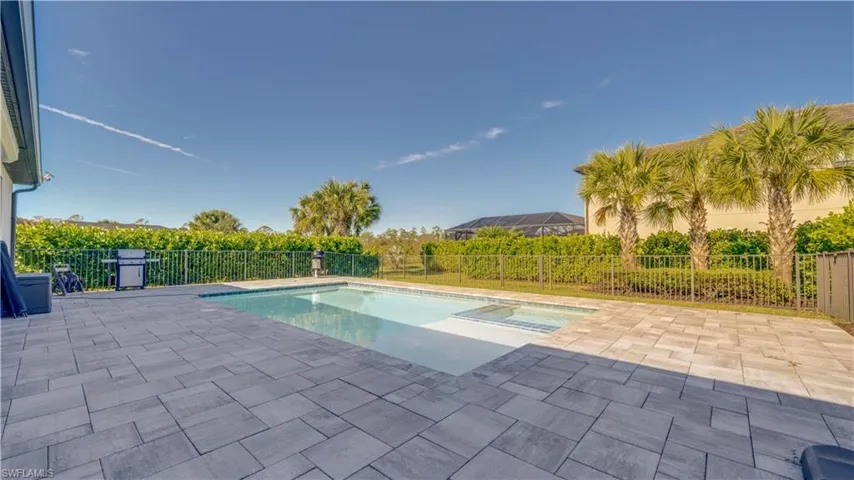 View of swimming pool with a patio and a fenced backyard