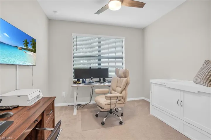Office space featuring light colored carpet and ceiling fan