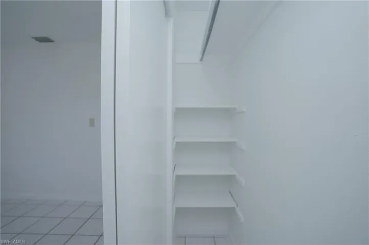 This property features an interior closet with built-in shelving, providing convenient storage