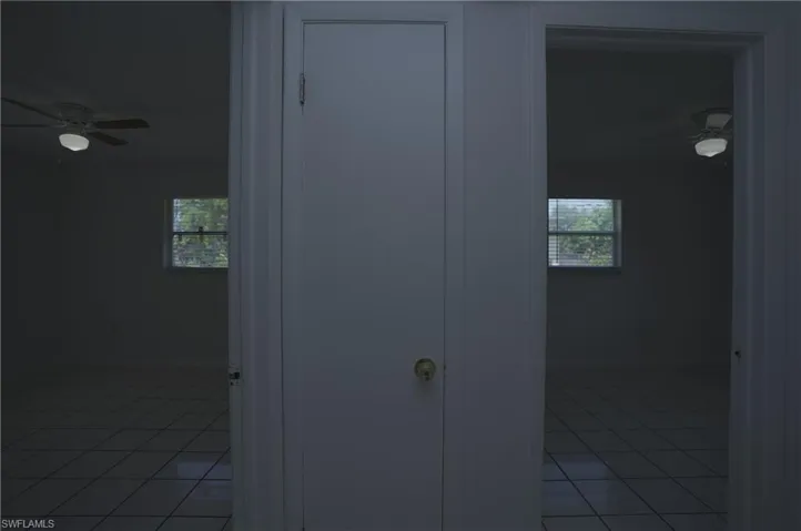 Each room features tiled flooring, a window with blinds, and a ceiling fan with an integrated light fixture