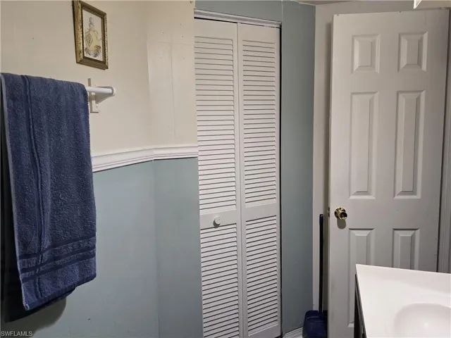 Bathroom featuring a closet and vanity