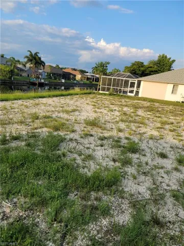 View of yard featuring a sunroom, a residential view, and glass enclosure