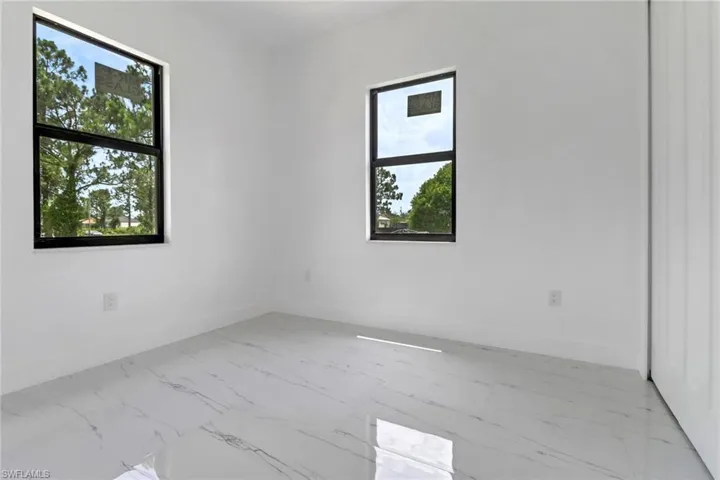 Spare room with marble look tile flooring